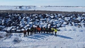 Project team at the Tuk Erosion Mitigation Project in Tuktoyaktuk, Northwest Territories, with newly installed rock shoreline erosion protection.
