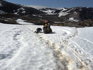 surveyors-struggle-to-move-cart-full-of-gear-in-snowy-conditions-cape-hopper-baffin-island-nunavut.